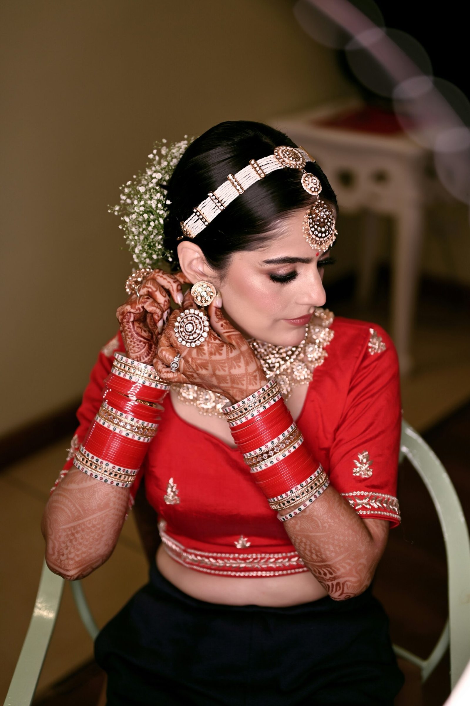 a woman in a red and black outfit is holding her hands to her face